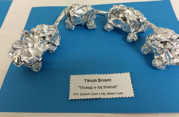 Mae Stevens Early Learning Academy Pre-kindergarten Student Tatum Bryant  reated his favorite storybook characters, Thomas the Train and Friends, from foil by wadding the usual art medium and then forming it into the figures to include event connectors for the train cars. The project was on display at an art gallery walk at the school.