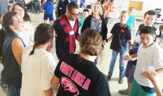 Leo Thompson, 11th grade CCHS Special Education student, leads others in a group dance at the Fall Festival Dance in Lampasas on Thursday.