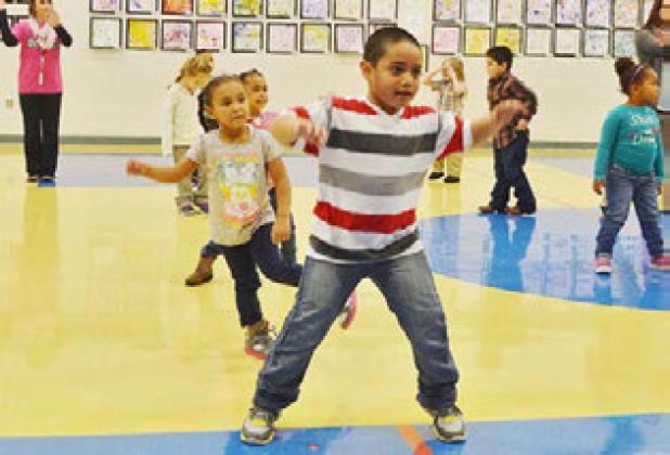Solomon Laloni and other prekindergarten students perform a dance routine on Wednesday morning