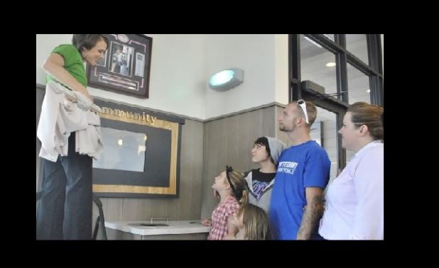Family of Jennifer Lathrop gather inside the Chick-Fil-A restaurant as a memorial is unveiled in the dining area of the restaurant.