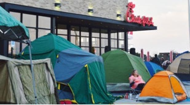 A tent city popped up overnight as patrons of Chick-Fil-A vied for a spot to be apart of the first 100 during the grand opening promotion receiving a free meal a week for a year.