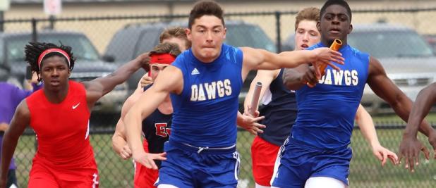 Copperas Cove’s Justin Joe passes the baton to anchor leg Andrew Leuthner on their way to a first place finish in the 4x100-meter relay Saturday at the 2014 Eagle Relays at East View High School in Georgetown. The Bulldawg boys finished in second place with 108 points.