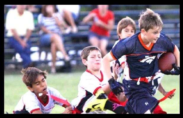 Broncos ball carrier Carson Brizendine is swarmed by Texan defenders, from left, Aiden Turner, Nick Harron and Ben Izquierdo during their 10-and-under flag football game on Saturday at Copperas Cove City Park’s Field 8. The Texans won both games of their double-header to take over the number one spot in 10U.