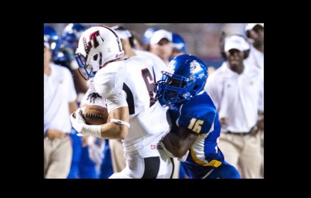 Cove senior defender Breyon Jackson shoves Lake Travis receiver Cade Green out of bounds during their game Friday at Bulldawg Stadium. Cove travels to Round Rock tonight to face the Dragons.