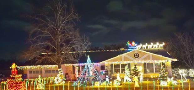 The home at 613 Cedar Drive is lit with two towering trees and features Santa and his sleigh on the roof. A digital countdown reminds visitors how many days are left until Christmas.