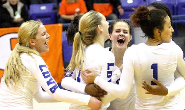 Members of the Lady Dawgs volleyball team celebrate their 3-1 (25-23, 22-25, 25-22, 28-26) win over the Rockwall Lady Jackets Tuesday night in Corsicana.