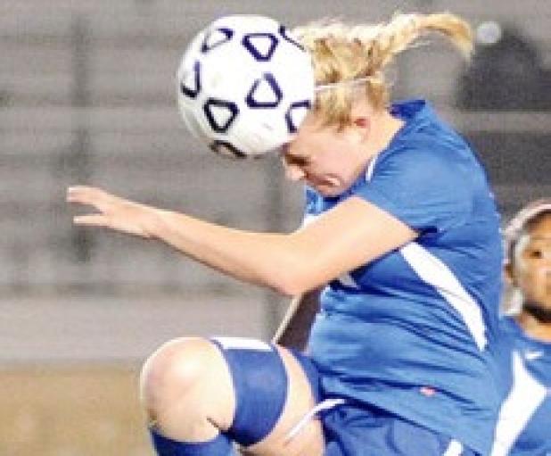 Shelbie Letzer heads a midfield air ball in the bi-district loss to Longview in Corsicana during the 2012-13 season.