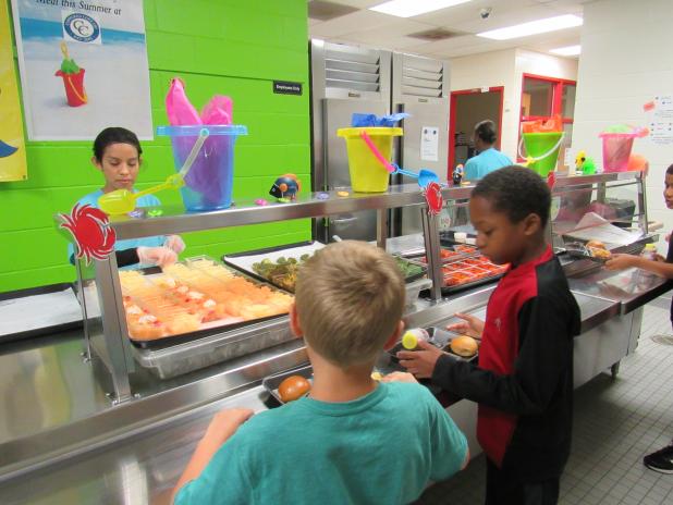 Kids make their way through the serving line during a past summer feeding program. 