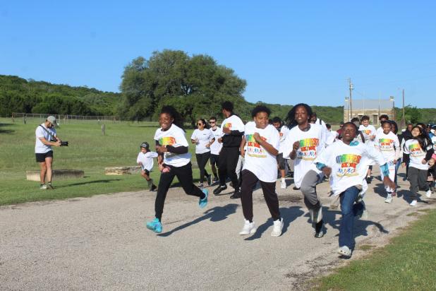 Runners take off at the start of Saturday's Mayfest 5K fun run. 