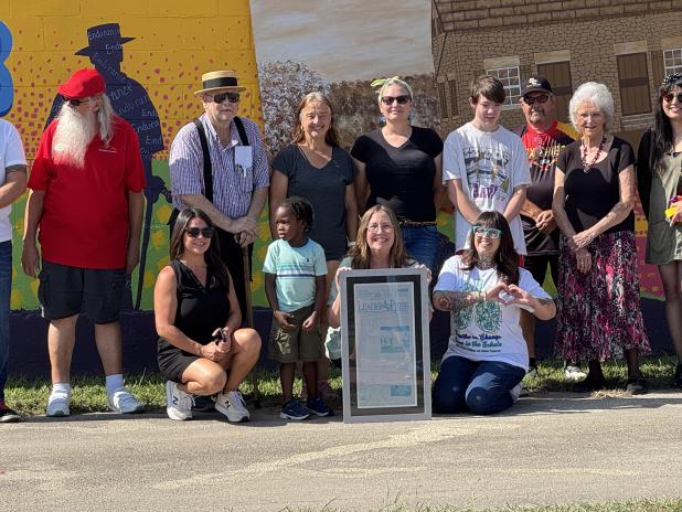 Volunteers celebrate the completion of the newest mural in downtown Copperas Cove.