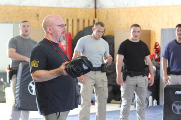 CTC Protective Services Professor Patrick Boone demonstrates proper arrest and control techniques to Bravo Class cadets during Police Academy training.