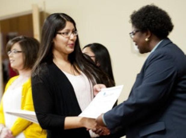 Copperas Cove ISD Board of Trustees secretary Inez Faison, right, presents Ashley Solis with her Campus Hero certificate for the volunteer works she along with 25 others were honored Friday.