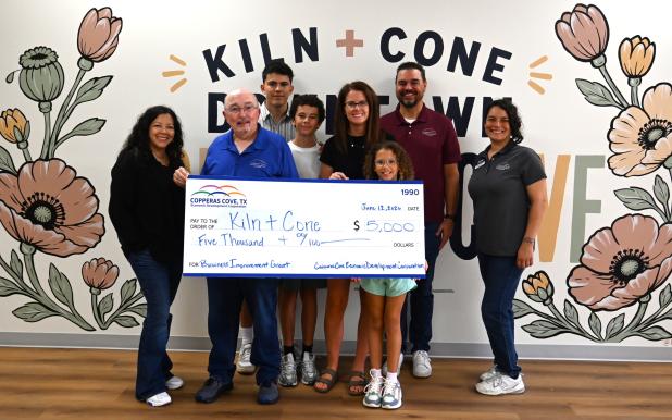 Ashley Lyons, owner of Kiln + Cone, is pictured with the Copperas Cove EDC staff and a $5,000 grant check. The grant funds are matching funds that were used to renovate Kiln + Cone, set to open this summer in downtown Copperas Cove.. 