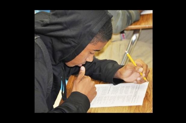 CCHS Senior basketball player Eric Braddock tests his English knowledge on a worksheet in a tutoring session he attends voluntarily to improve his test scores to get into college.