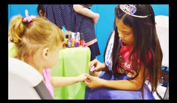 Natalie Perez, Preteen Miss Rabbit Fest, paints fingernails at the Pretty Princess Parlor at Saturday’s YMCA back to school party.