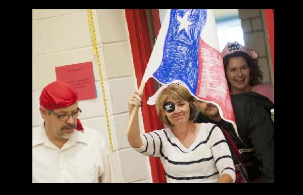 Staff from Williams Ledger Elementary make their way into the gymnasium with pirate attire on as they prepare for the initial workshop in the five part series Learn to Teach like a Pirate.
