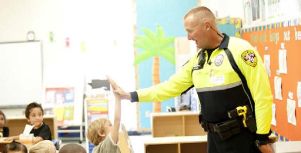 Copperas Cove Police Officer James Dudden gives out high fives to the students of Mae Stevens Early Learning Academy as he helps share the message of being drug free during Red Ribbon week across the district.