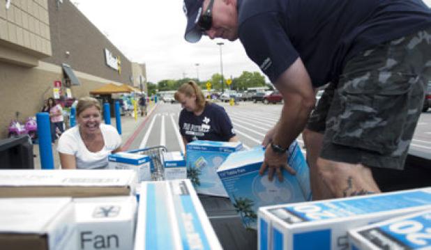 Donald Vess loads his truck with fans with the help of Chamber of Commerce Ambassadors Nicole Vess and Brenda Wilson following a food and fan drive that netted nearly two dozen fans for the seniors of Copperas Cove.