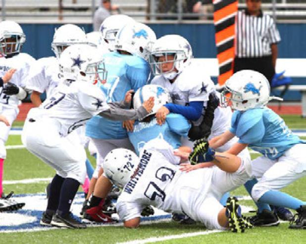 A swarm of Cowboys defenders takes down Lions ball carrier Gabriel Rodriguez in their 32-6 win over the Lions on Saturday. The win improved the Cowboys to 2-2 and the Lions fall to 0-4 on the season.