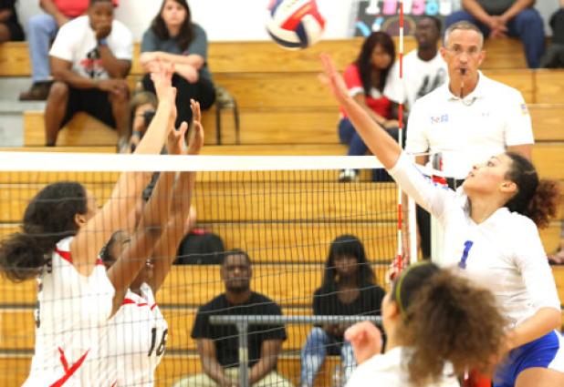 Copperas Cove senior Mikayla Blount, right hits into the defense of Harker Heights’ Torie Joiner, left, and Aennetra Hall during the Lady Dawgs’ 3-0 (25-16, 25- 21, 25-9) sweep of the Lady Knights.