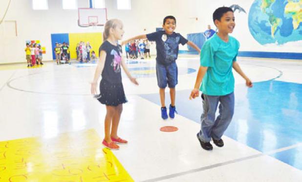 Second graders at Halstead Elementary do jumping jacks at Friday’s mathnasium.