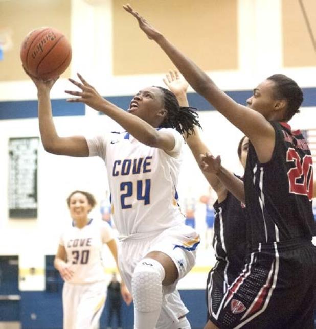 Copperas Cove senior Kenya Haynes streaks to the basket in front of a pair of Lady Knights’ defenders during their 72-62 win on Friday. Haynes was one of five Lady Dawgs to score in double-digits. 