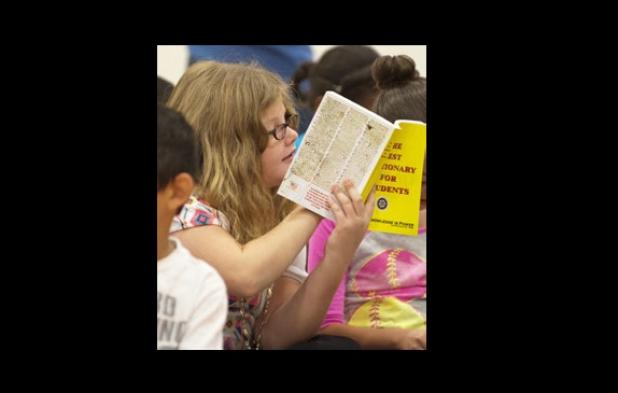 Alexi Dickson, 9, reads through her dictionary during an assembly at Williams Ledger Elementary School.