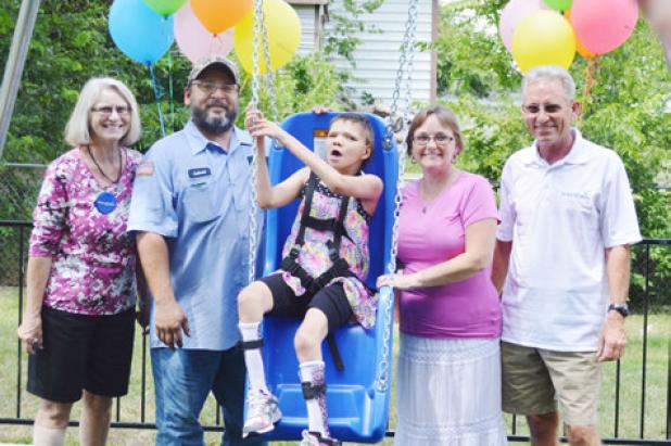 Mona Lopez enjoys her new play area from the Make-A-Wish Foundation. Left to Right: Cindy Daly, Gabriel Lopez, Mona, Mira Lopez, Bill Daly.