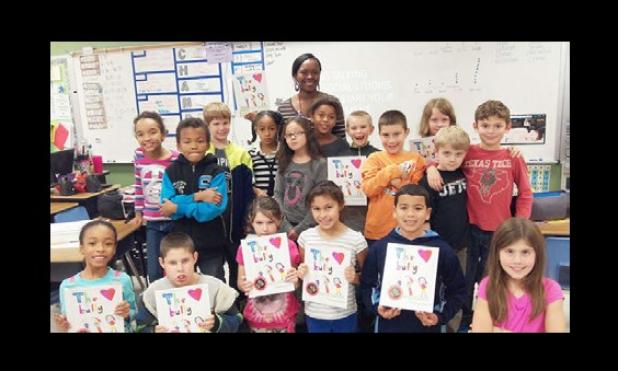 Third grade students in Denise Carmichael’s class at House Creek Elementary School show off their newly published books containing their opinions of bullying. Students were involved in the entire writing process to prepare and create the book including brainstorming a topic as a class and outlining the story elements of the book.