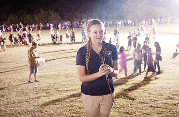 Mikayla Miller speaks into the microphone as she gives an account of the night’s activities to Copperas Cove Public Information Officer Kevin Keller for the government channel broadcast.