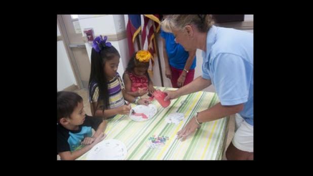 Keli’i Natividad, 4, Pe’ela alemene , 8, and Ko’elani Palemena, 5, get help with their pizza sauce as they create their Garbage Pizza pie Tuesday afternoon at the Copperas Cove Public Library.