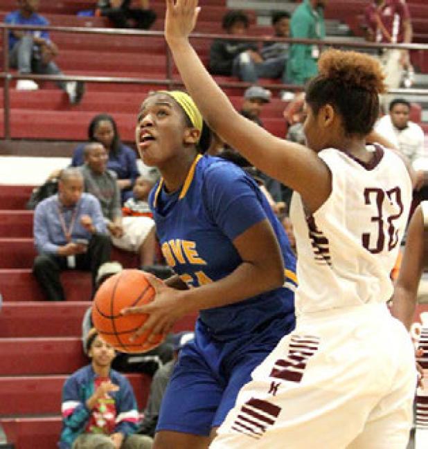 Cove sophomore Chyanne Chapman attempts a shot in front of Killeen sophomore Jacen Moore during their game Tuesday in Killeen. The Lady Roos won 54-44