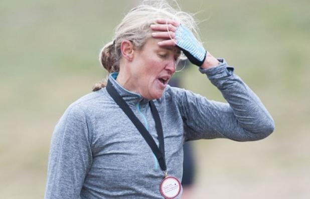 Trisha Bonilla tries to catch her breath after finishing sixth overall in the 10th annual Tough Cookie race Sunday morning.