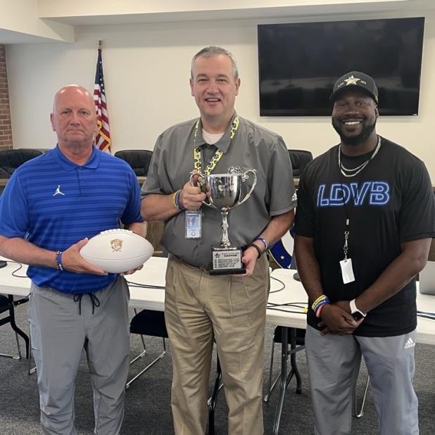 Courtesy photo:  Bulldawgs Head Coach and Athletic Director Rodney Southern, CCISD Superintendent Brent Hawkins, and Coach Donald Buckram Jr. show off the Peanut Butter Bowl trophy. Copperas Cove has won the Peanut Butter Bowl two out of three years. 