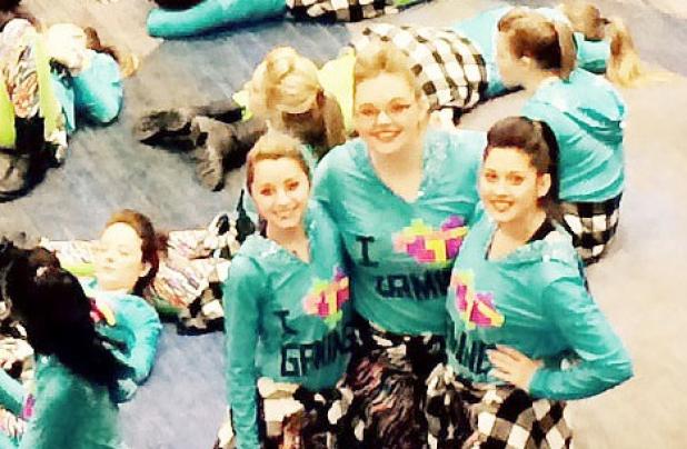 Emily Drever, Lauren Castaneda, and Ashley Johnson take a break from rehearsal for a quick photo before heading into the next practice session for the Macy’s Thanksgiving Day Parade in New York City.