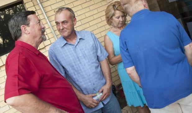 George Duncan, center, congratulates Kirby Lack, left, after results of the Special Election are posted on the old City Hall doors. Lack received the most votes but not enough to claim the election outright, forcing a runoff with Azeita Taylor.