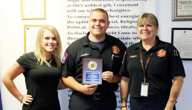 Dylan Karl, center, was honored as the firefighter of the quarter by the morning exchange club. Presenting him for the award is Captain Carla Polidoro and his fiancee Jamie McCartney.
