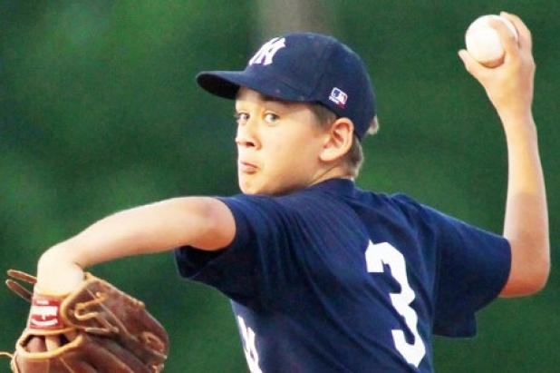 15U Yankees’ Jacob Wagner starts his windup on the mound during the fifth inning of their 14-7 win over the Cubs on Tuesday. Wagner picked up the win after coming in at a 5-5 tie to start the fourth inning.