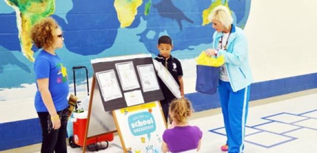 CCISD’s Director of Child Nutrition congratulates the art contest winners at Halstead Elementary after breakfast on Thursday morning during National School Breakfast Week.