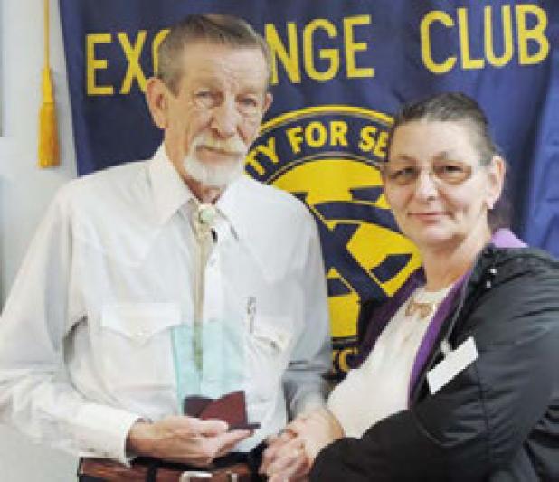 Cove Board Member Angela Fields presents Exchange Sunshine Home Apartments resident Michael Quick with the Senior Citizen of the Third Quarter Award. Quick was selected because of his volunteer work and assistance he offers other residents.