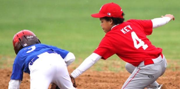 Justin Best of the Royals 12U baseball team stumbles in to second base in front of the tag attempt of Cardinals shortstop Josiah Key during their Copperas Cove Parks and Recreation league game Tuesday at Copperas Cove City Park.