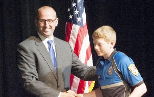 William Horton shakes the hand of Coryell County District Attorney Dusty Boyd after accepting his certificate of completion from Law Enforcement Explorers Program Friday evening.
