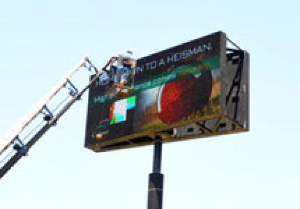 A work crew repairs a portion of the EDC digital sign that was damaged
in the spring hail storms.