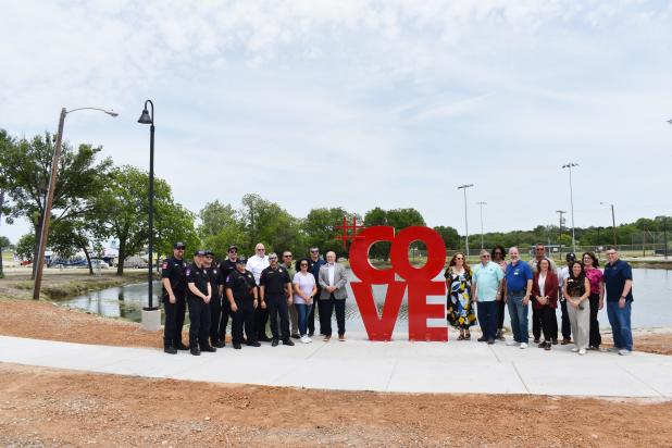 CCLP/PAMELA GRANT -- Covites pose alongside the new “#COVE” sign at City Park.