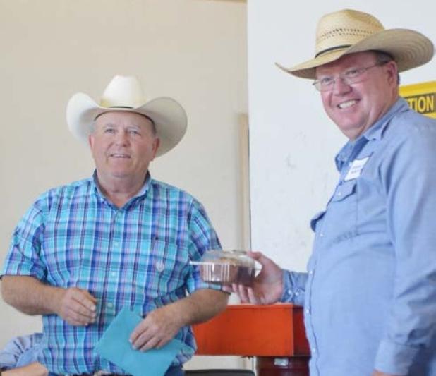 Coryell County’s road and bridge administrator, Allen Neel, receives a retirement gift from his department at a luncheon on Tuesday. Pictured with Neel is Timothy Clary, the county’s new interim road and bridge administrator