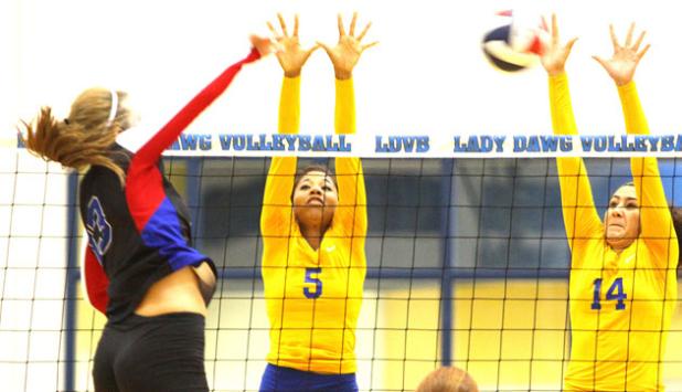 Copperas Cove’s Raven Dickerson (5) and Megan Diaz leap for a block attempt against Midway hitter Allison Jones during their 2.5 hour, five-set contest Tuesday at Bulldawg Gymnasium. The Pantherettes won 3-2 (30-32, 25-21, 25-20, 22-25, 6-15).