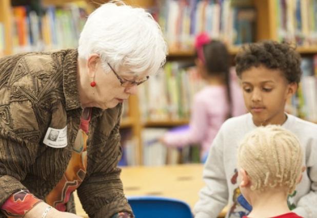 Marianne McDonnell helps kindergarten students browse through books as they select one to keep. The Copperas Cove Retired Teachers Association donated close to 600 books to the students of the district throughout the school year.