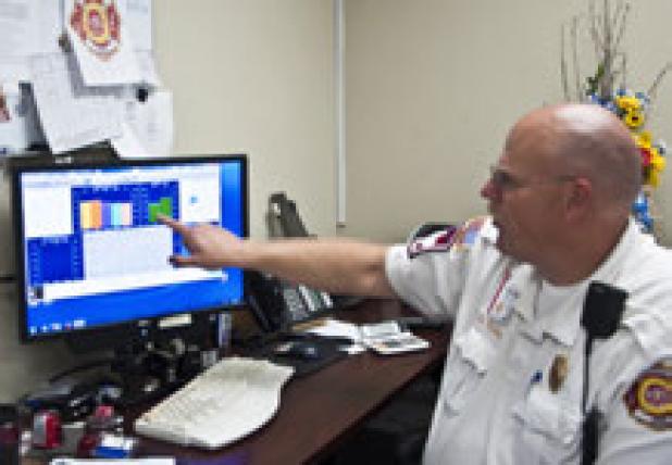 Emergency Management Coordinator and Deputy Fire Chief, Gary D. Young views the weather station data from his computer in his office.
