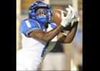 CCLP/LEE LETZER - Cove senior Isaiah McGriff hauls in a 54-yard touchdown pass to give Cove a 17-14 lead in the second quarter against Midway on Friday. The Dawgs eventually fell 48-24.