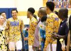 CCLP/TJ MAXWELL - Copperas Cove senior Malyk Thomas is escorted out by his parents as part of senior night festivities prior to the Bulldawgs 105-64 win over the Kangaroos on Friday.